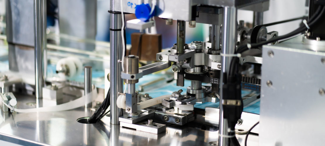 Machines are working for producing masks in a sterile factory. Production of medical masks. process of manufacturing a mask
